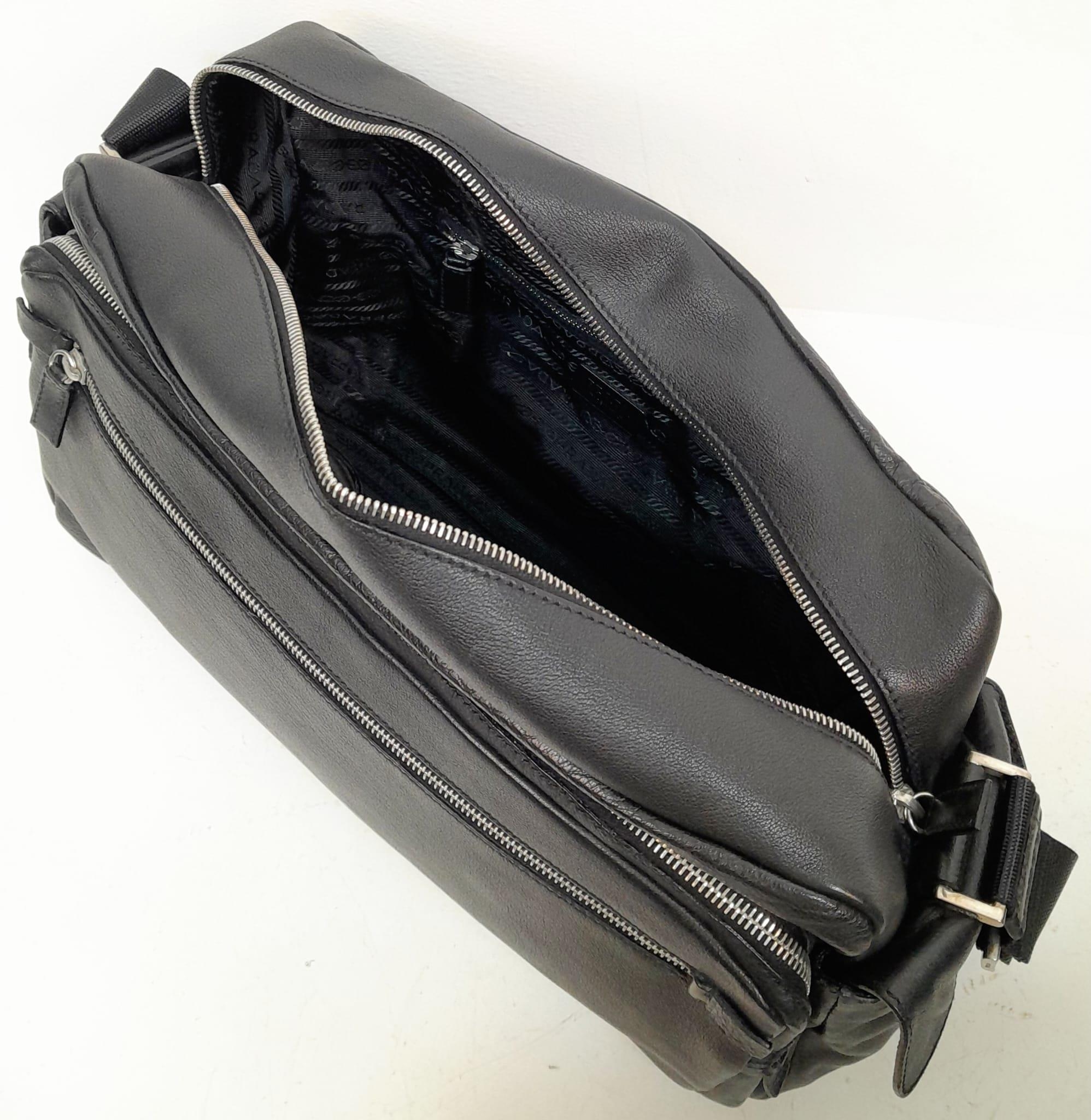 A Prada Black Duffle Bag. Leather exterior with silver-toned hardware, zipped outer compartment to - Image 9 of 12