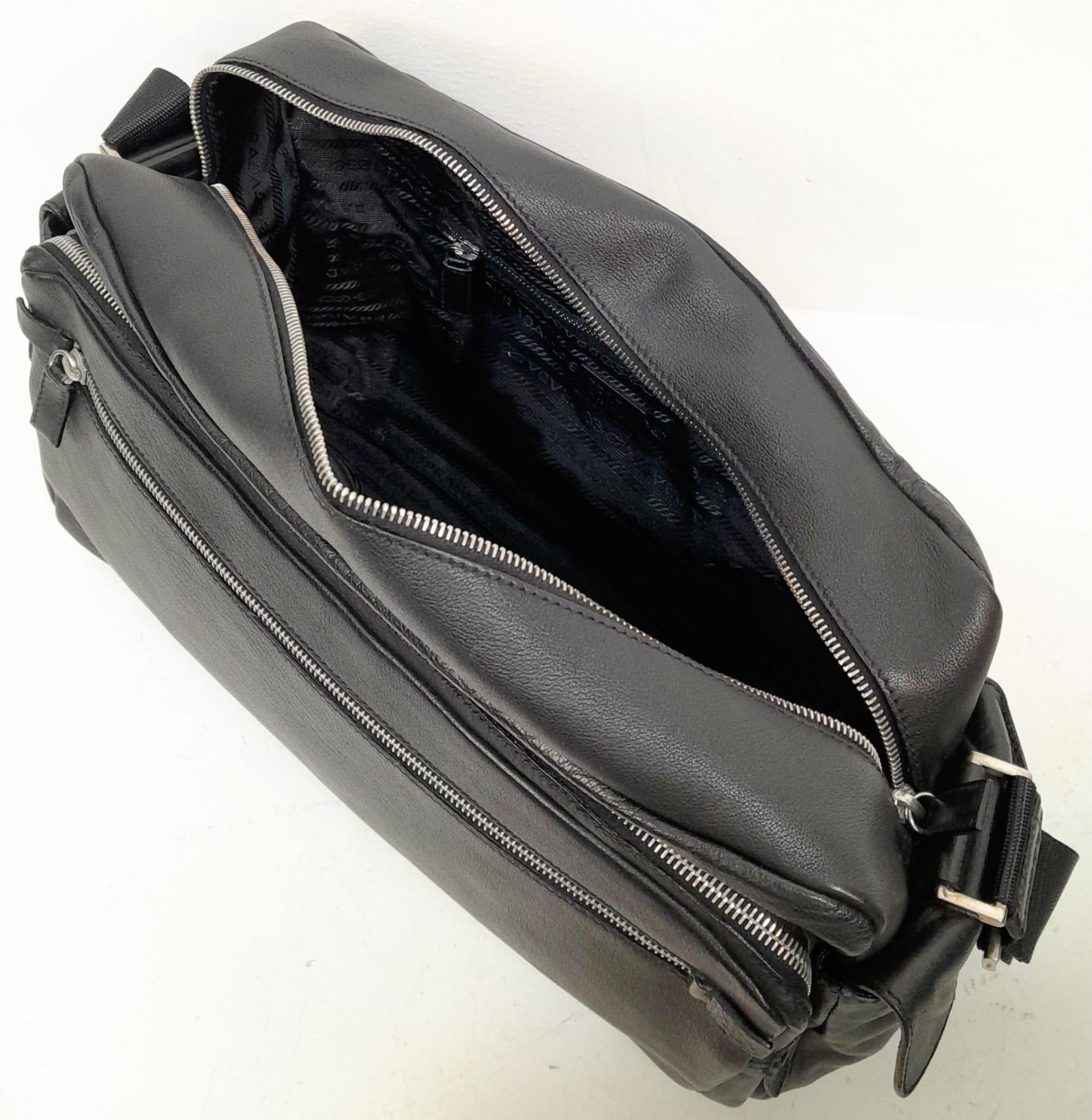 A Prada Black Duffle Bag. Leather exterior with silver-toned hardware, zipped outer compartment to - Bild 9 aus 12