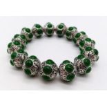 A Tibetan Silver and Green Jade Expandable Bracelet. Decorative jade cabochons and ancient Tibetan