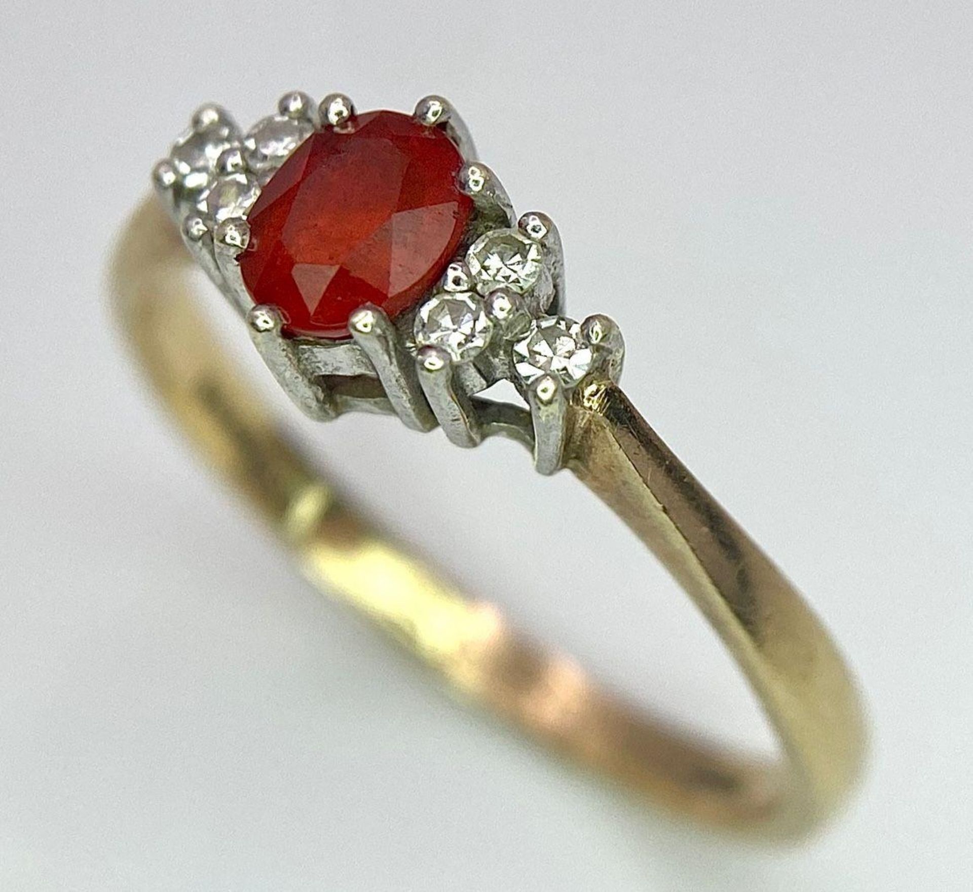 A Vintage 9K Yellow Gold, Red Sapphire and Diamond Ring. Oval sapphire with diamond accents. Size O. - Image 3 of 8