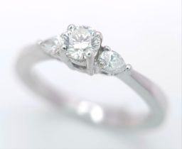 AN 18K WHITE GOLD DIAMOND RING WITH PEAR SHAPED DIAMOND ACCENTS ON SHOULDERS. 0.40CTW OF PEAR SHAPED