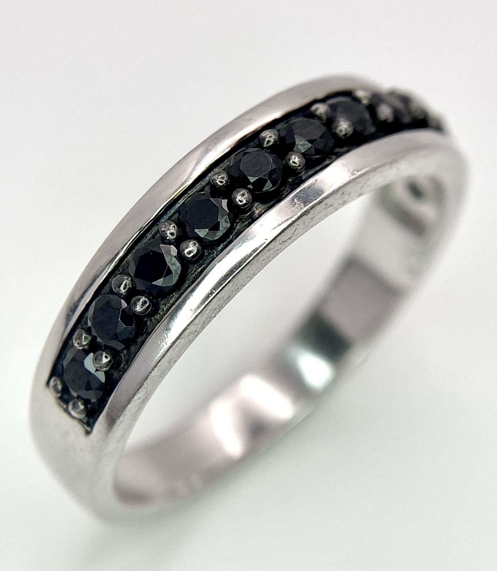 A 925 Silver and Sapphire Half Eternity Ring. Size X.