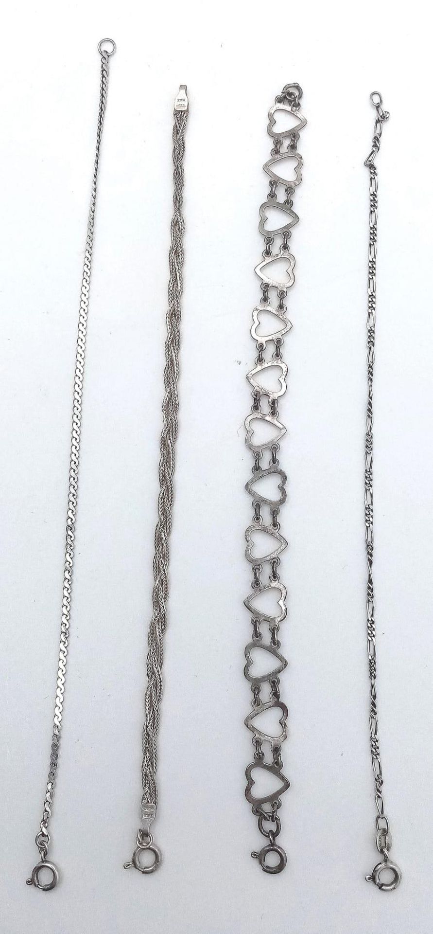 A collection of 4 stylist sterling silver bracelets include a figaro link, twisted, heart link and - Image 5 of 13