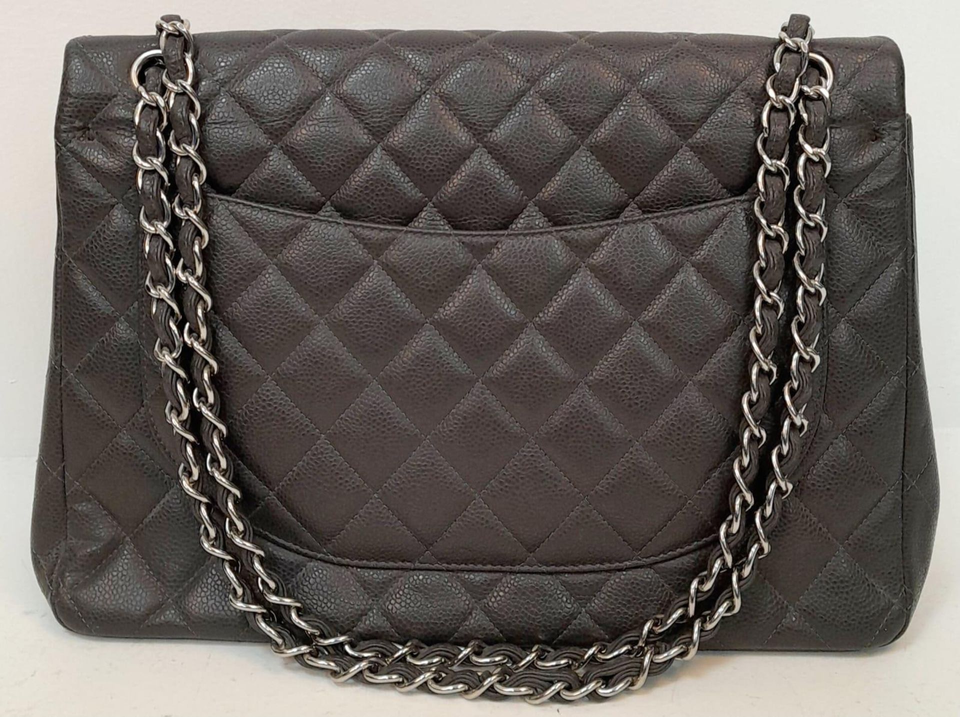 A Chanel Jumbo Double Flap Maxi Bag. Dark grey quilted caviar leather exterior with a large slip - Image 2 of 12