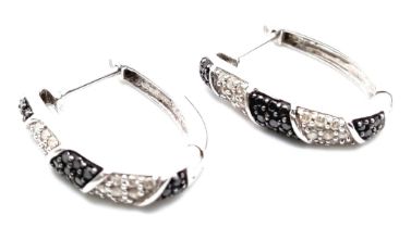 A Pair of 9K White Gold, Black & White Diamond Set Earrings. 0.40ctw, 2cm length, 5g total weight.