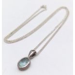 A Sterling Silver Blue Topaz Pendant on Chain. 1.8cm pendant, 46cm chain, 4.7g total weight. Ref: SC