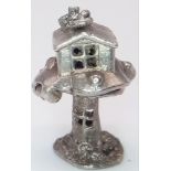 A VINTAGE STERLING SILVER TREE HOUSE CHARM, WHICH OPENS TO REVEAL A WIZARD INSIDE, WEIGHT 4G