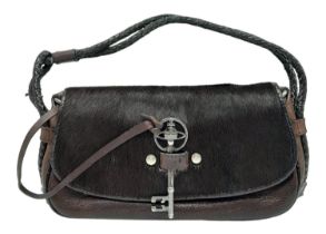 A Vintage Vivienne Westwood Handbag. Brown leather and pony hair exterior. Key clasp. Red textile