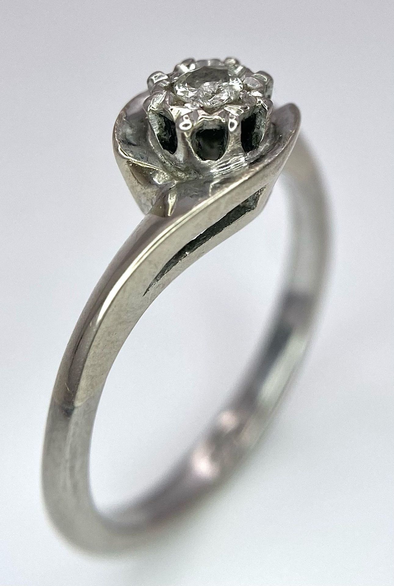 An 18K White Gold Diamond Crossover Ring. 0.10ct brilliant round cut diamond. Size N. 4g total - Image 2 of 6