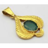 A 22K Yellow Gold and Emerald Pendant. Decorative leaf pattern with a central oval emerald. 4cm. 4.