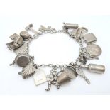 A Sterling Silver Charm Bracelet with 23 Charms. 18cm length, 48.5g total weight. Ref: SC 7088