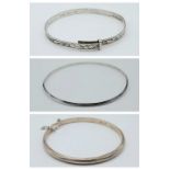 A collection of 3 silver bangles (A/F). One of them marked with 835 silver, the others are click-