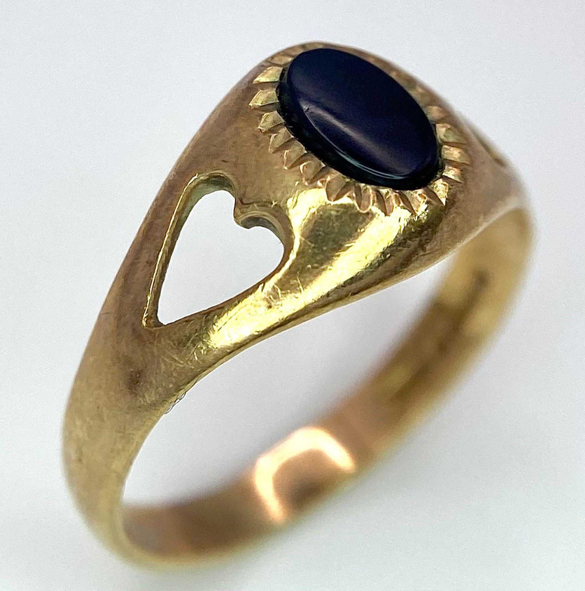 A 9K Yellow Gold Black Onyx Ladies Ring. Size K. 1.83g total weight.