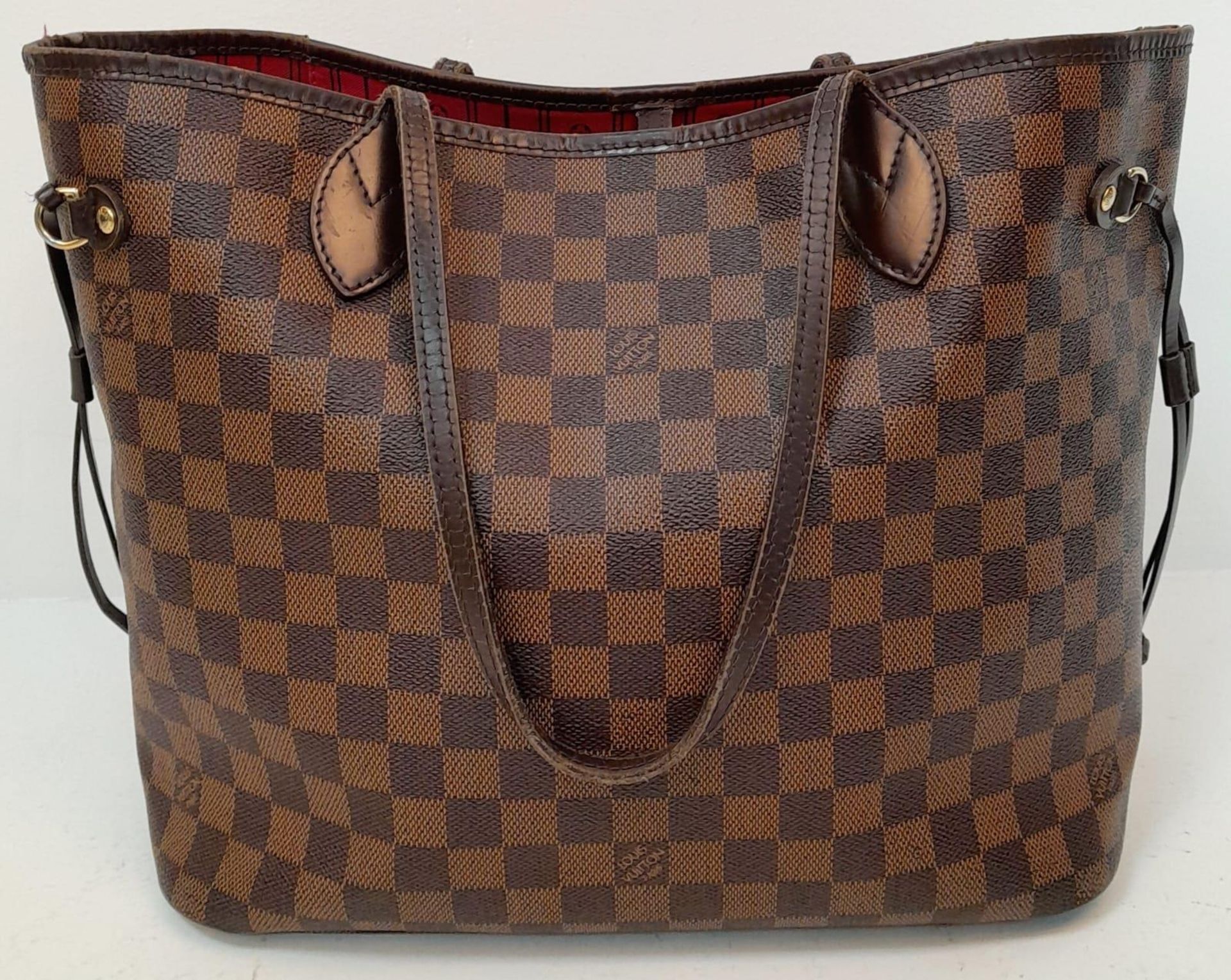 A Louis Vuitton "Neverfull" Damier Ebene Bag. Size MM. Leather Exterior Coated Canvas with gold-