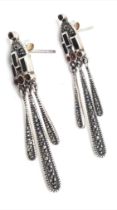 A fancy pair of 925 silver tribal style Garnet stone set earrings. Total weight 4.6G.