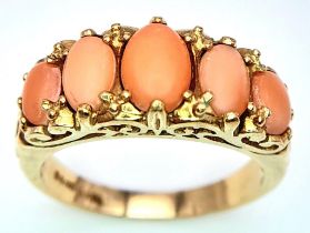 A 9K YELLOW GOLD CORAL 5 STONE RING. 4G. SIZE O.