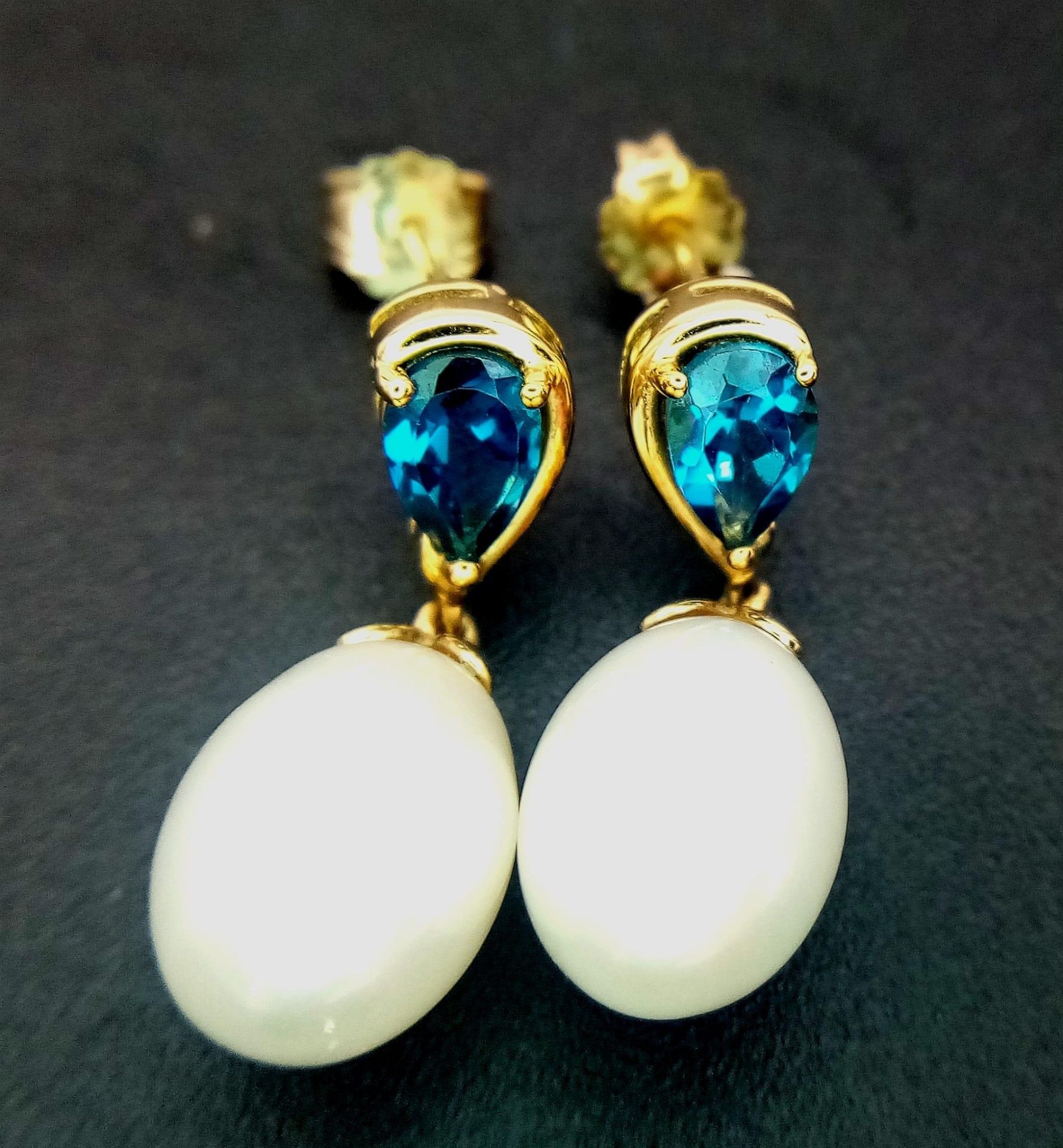 A Pair of White Pearl and London Blue Topaz 9K Gold Drop Earrings. 3.6g total weight.