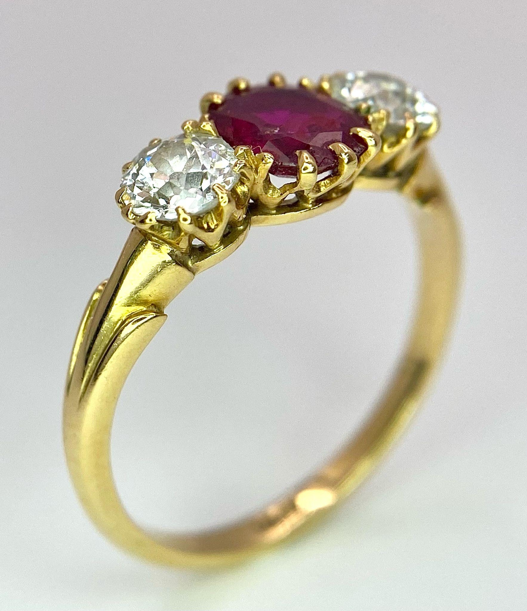 A Mesmerising 18K Yellow Gold, Ruby and Diamond Ring. A deep red oval cut ruby sits central - Image 3 of 9