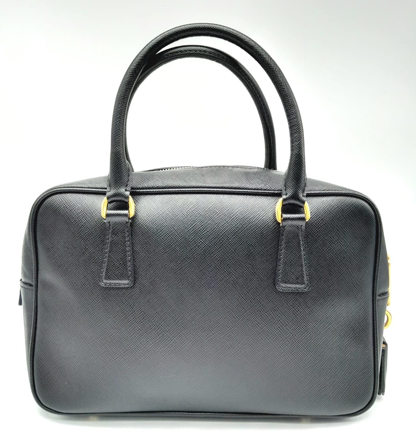 A Prada Black Bauletto Handbag. Saffiano leather exterior with gold-toned hardware, padlock, 2 - Image 3 of 11