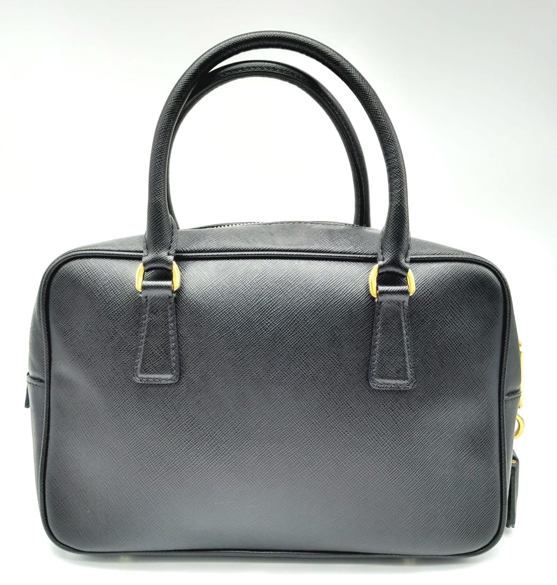 A Prada Black Bauletto Handbag. Saffiano leather exterior with gold-toned hardware, padlock, 2 - Bild 3 aus 11