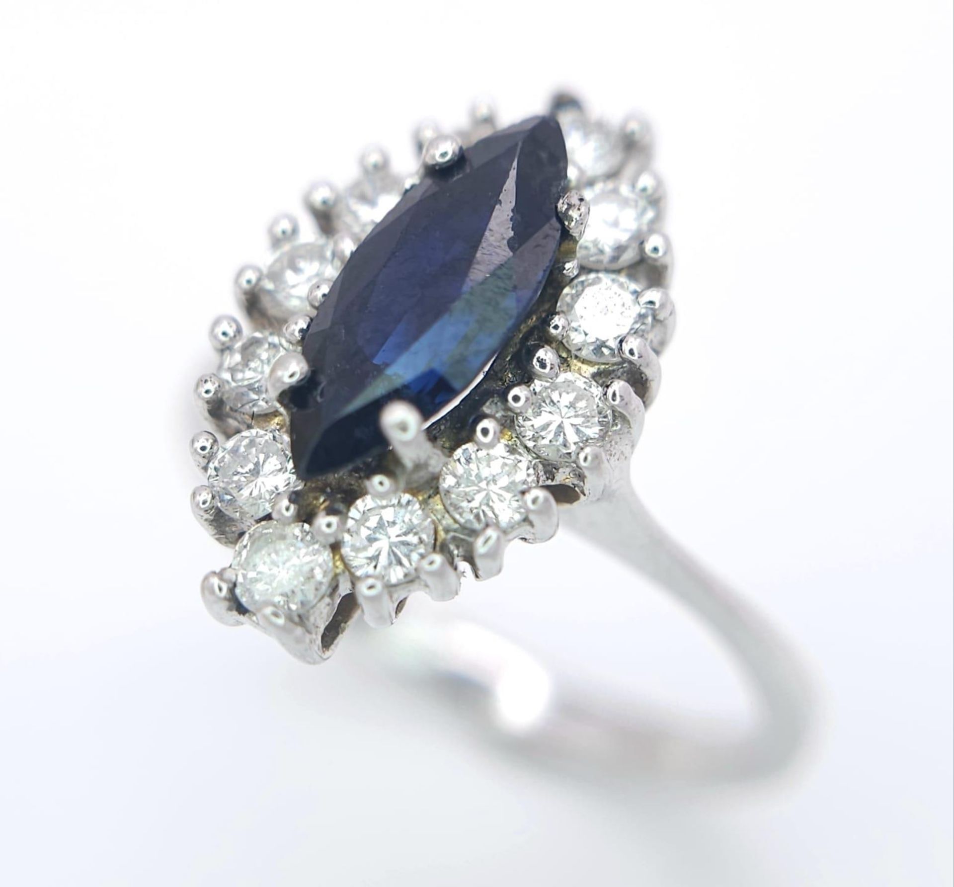 AN 18K WHITE GOLD DIAMOND & SAPPHIRE MARQUISE SHAPE RING. 0.40CTW OF DIAMONDS AND A 1.20CT