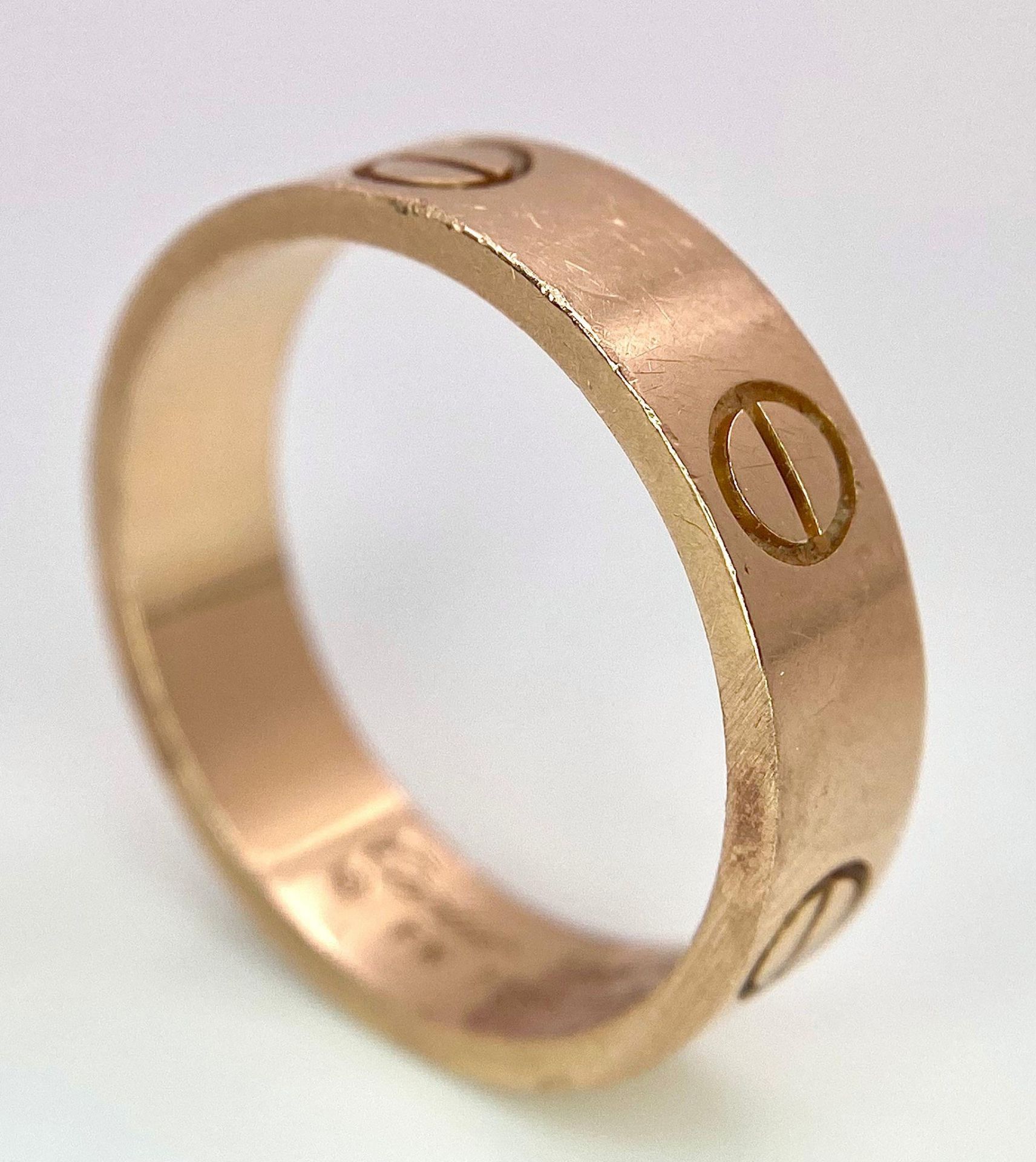 A Cartier 18K Rose Gold Love Band Gents Ring. 6mm width. Cartier hallmarks. Size W. 8.6g weight.