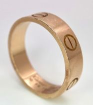 A Cartier 18K Rose Gold Love Band Gents Ring. 6mm width. Cartier hallmarks. Size W. 8.6g weight.