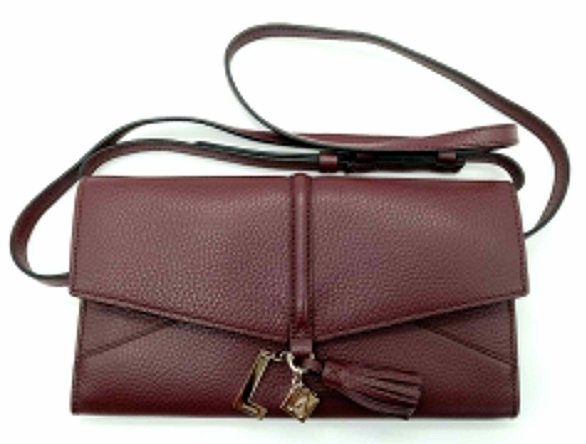 A Lance Burgundy Leather Hand/Shoulder Flap Bag. Textured leather exterior. Soft red textile