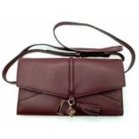 A Lance Burgundy Leather Hand/Shoulder Flap Bag. Textured leather exterior. Soft red textile