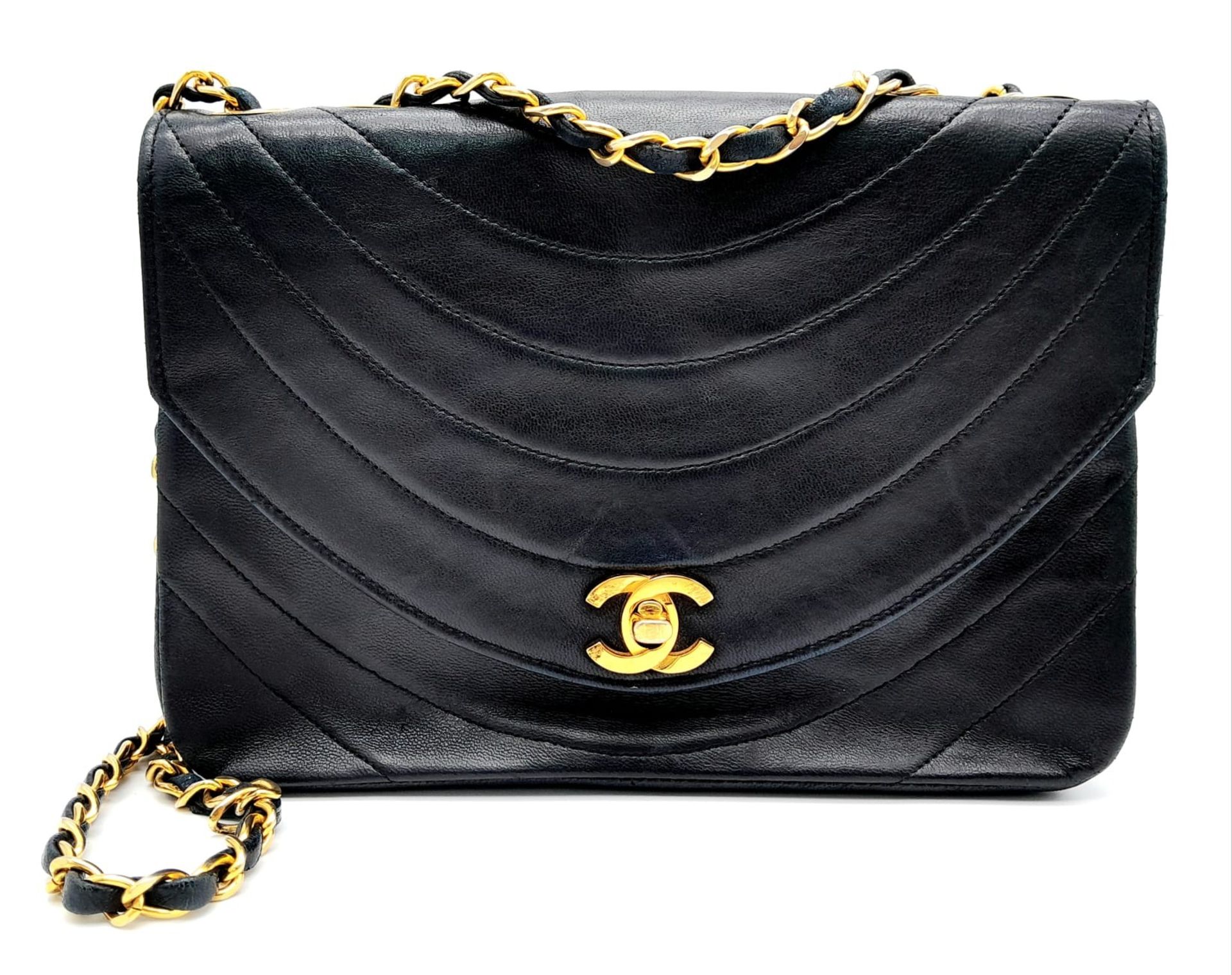 A Chanel (Coco Mark) Lambskin Single Flap Double Chain Bag. Gold tone hardware including CC clasp.