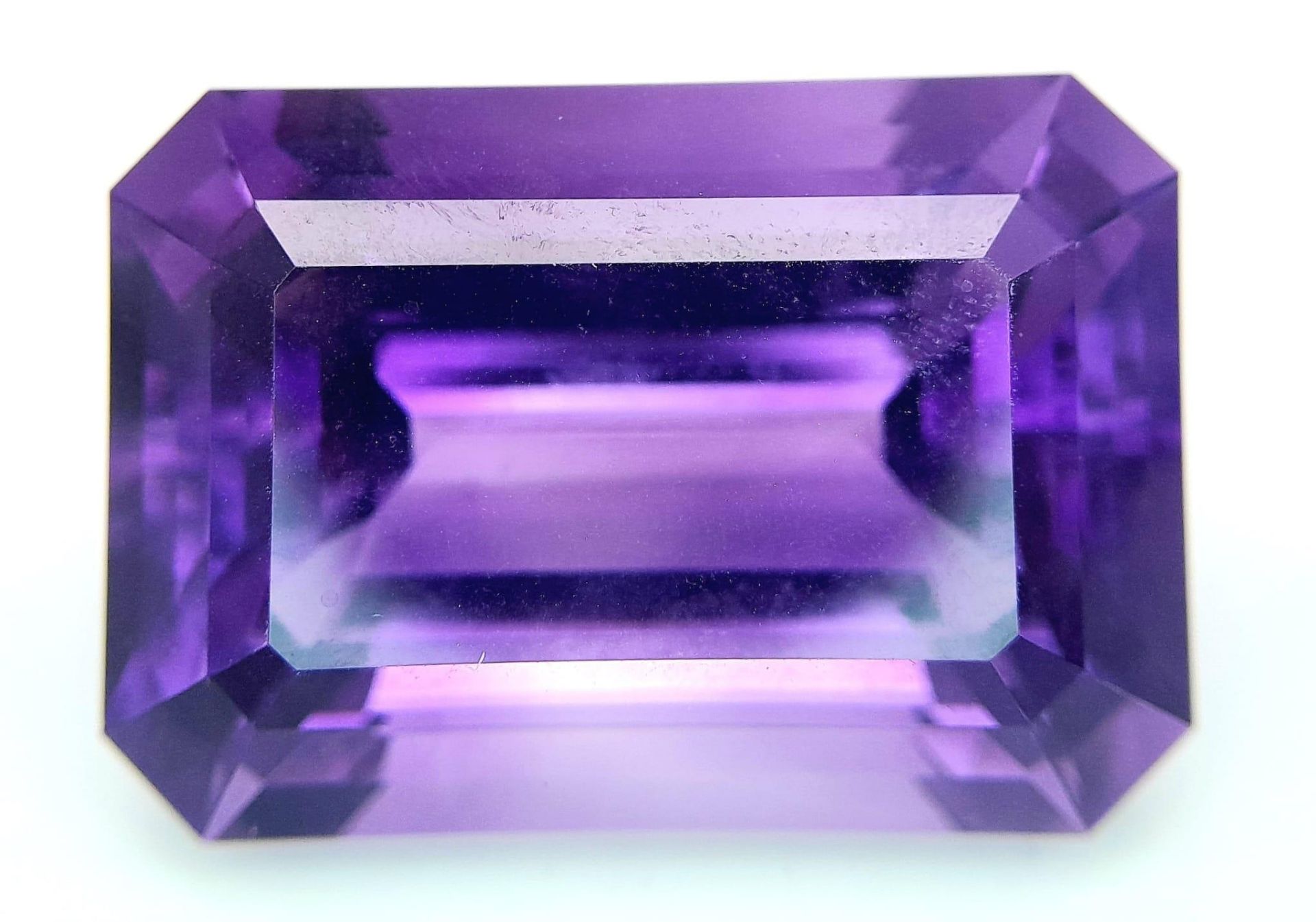 A large (92.03 carats), octagonal step cut AMETHYST, with excellent vivid and uniform colouration