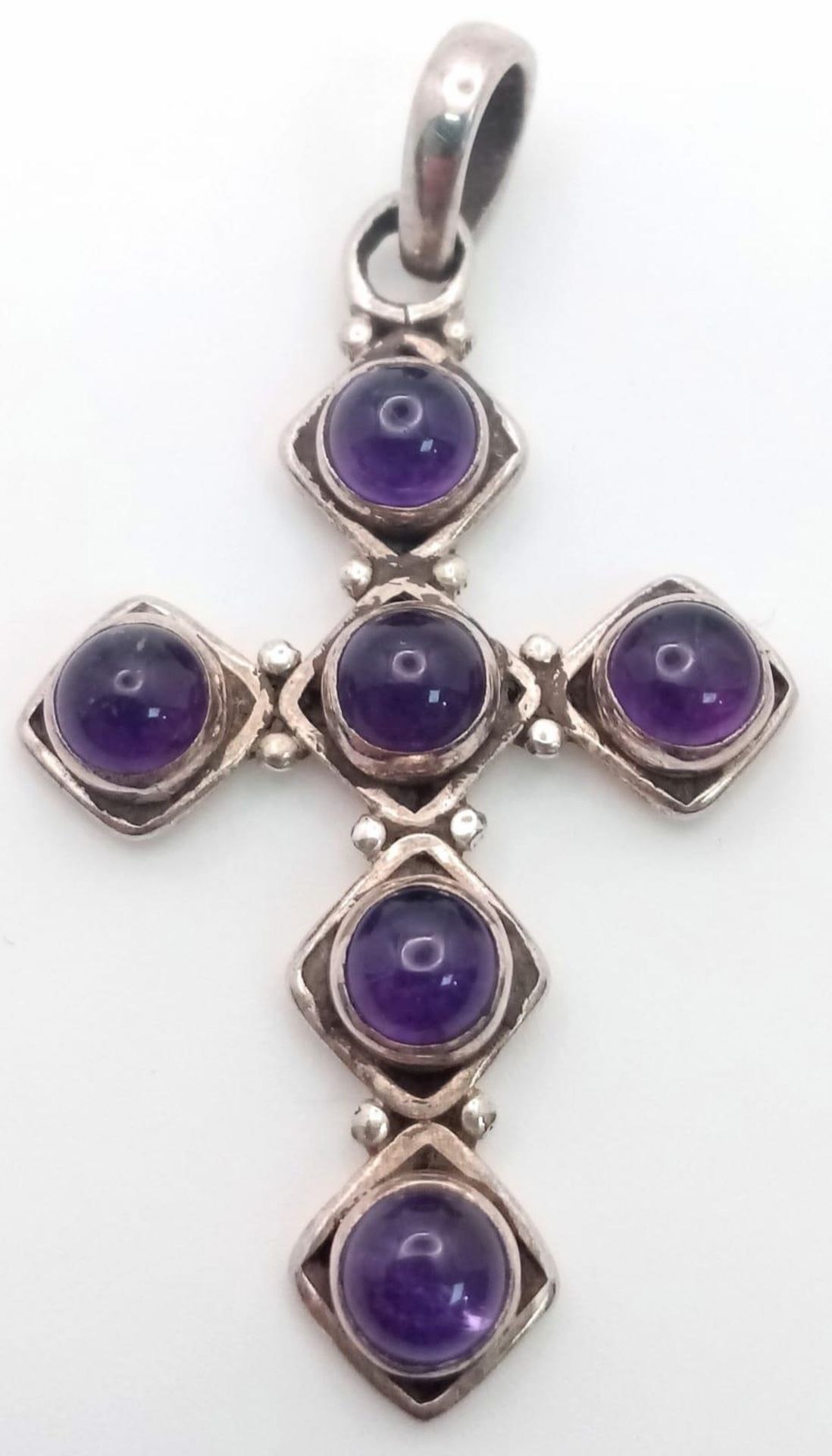 A Sterling Silver Amethyst Cabochon Cross Pendant. 4.5cm Length. Set with 4mm Round Cut Amethyst