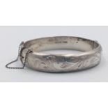 A 1994 Hallmarked Silver Scroll Detail Bangle by Henry Griffith and Sons Silversmiths. 6cm inner