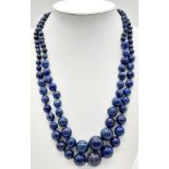 A Classic Lapis Lazuli Double Row Graduated Bead Necklace. 40-44cm length. Largest lapis bead -