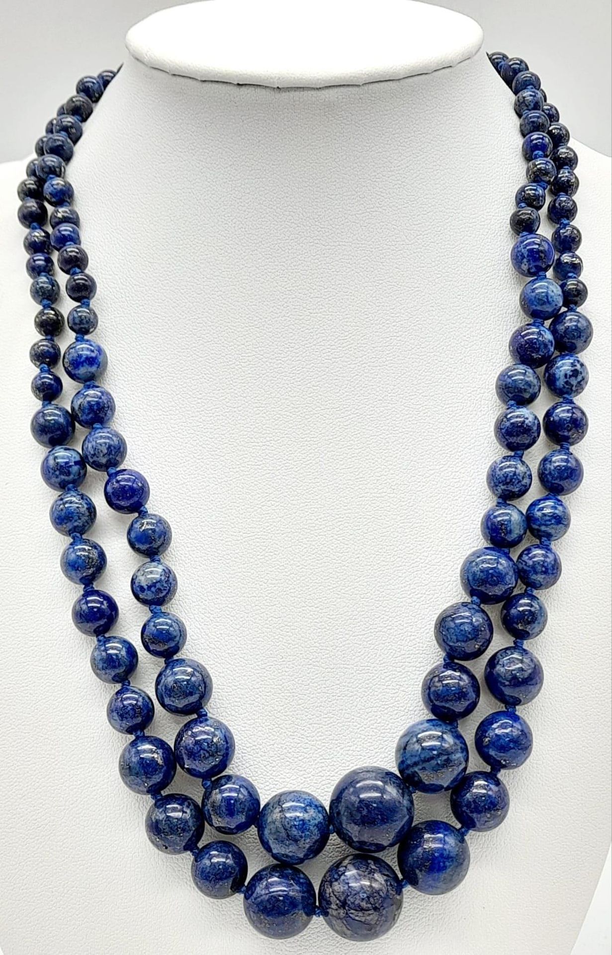 A Classic Lapis Lazuli Double Row Graduated Bead Necklace. 40-44cm length. Largest lapis bead -