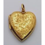 A p K yellow gold heart shaped locket with engraved front. Height (with bail): 32 mm, weight: 8 g.