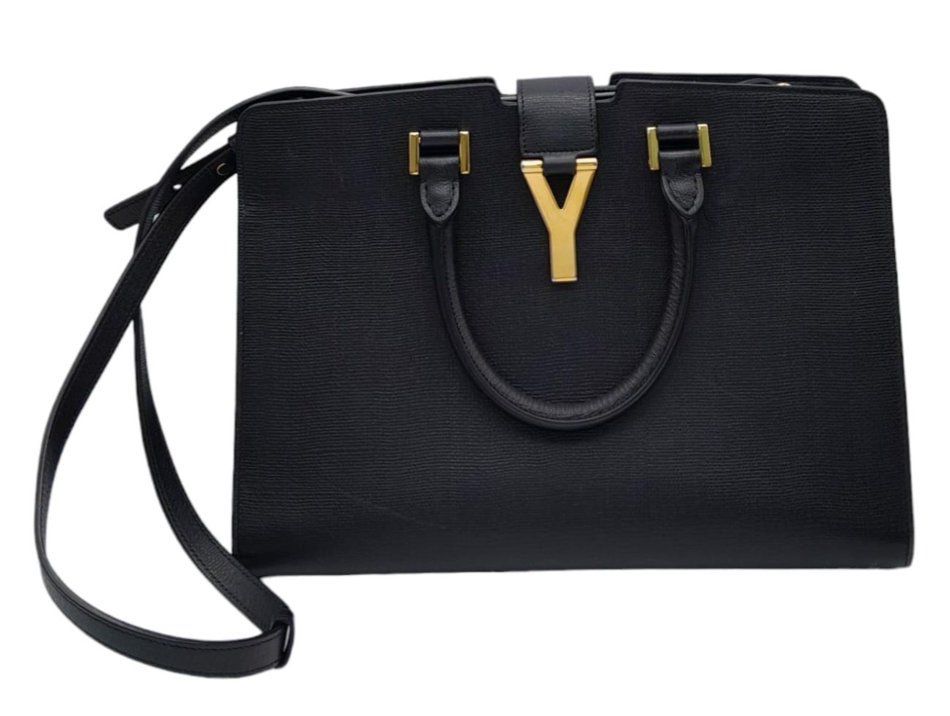 An Yves Saint Laurent Black 'Cabas' Handbag. Leather exterior with gold-toned hardware, two rolled