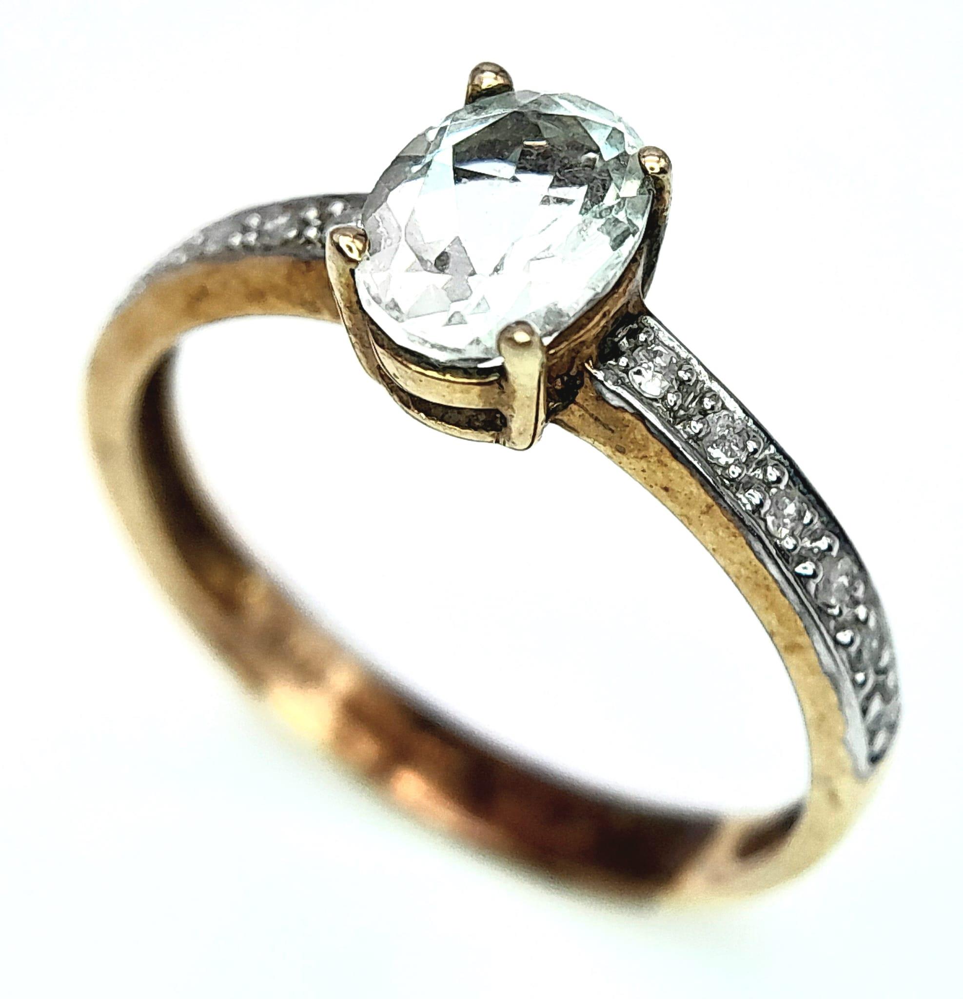 A 9K YELLOW GOLD DIAMOND & AQUAMARINE SET RING. OVAL AQUAMARINE GEMSTONE APPROX 0.75CT. 1.8G. SIZE N - Image 2 of 6