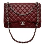 A Chanel Burgundy Jumbo Classic Double Flap Bag. Quilted leather exterior with silver-toned