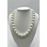 A White South Sea Pearl Shell Bead Necklace. 14mm beads. 44cm necklace length. Heart clasp.