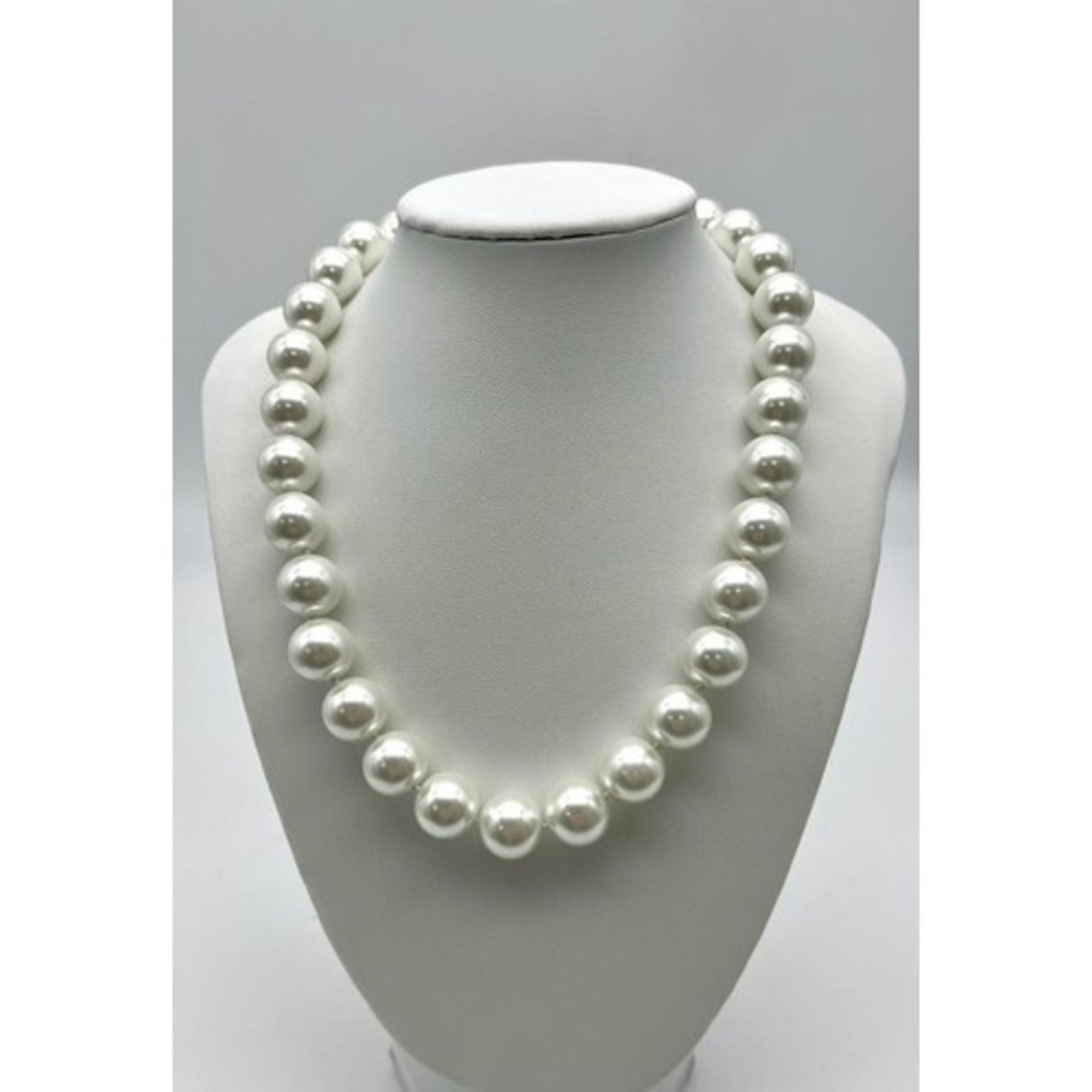 A White South Sea Pearl Shell Bead Necklace. 14mm beads. 44cm necklace length. Heart clasp.