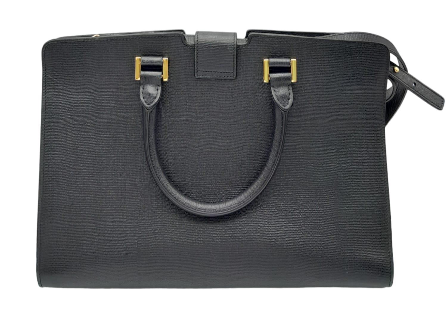 An Yves Saint Laurent Black 'Cabas' Handbag. Leather exterior with gold-toned hardware, two rolled - Image 4 of 8