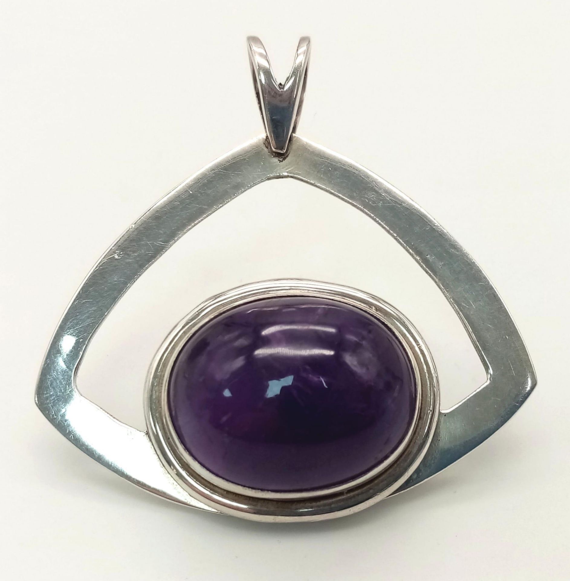 A Modernist Design, Sterling Silver, 2.4cm Length Oval Cut Amethyst Cabochon Pendant. The Pendant