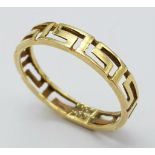 A nice 9 K yellow gold band ring with the Greek key design all around it. Size: K, weight: 1 g.