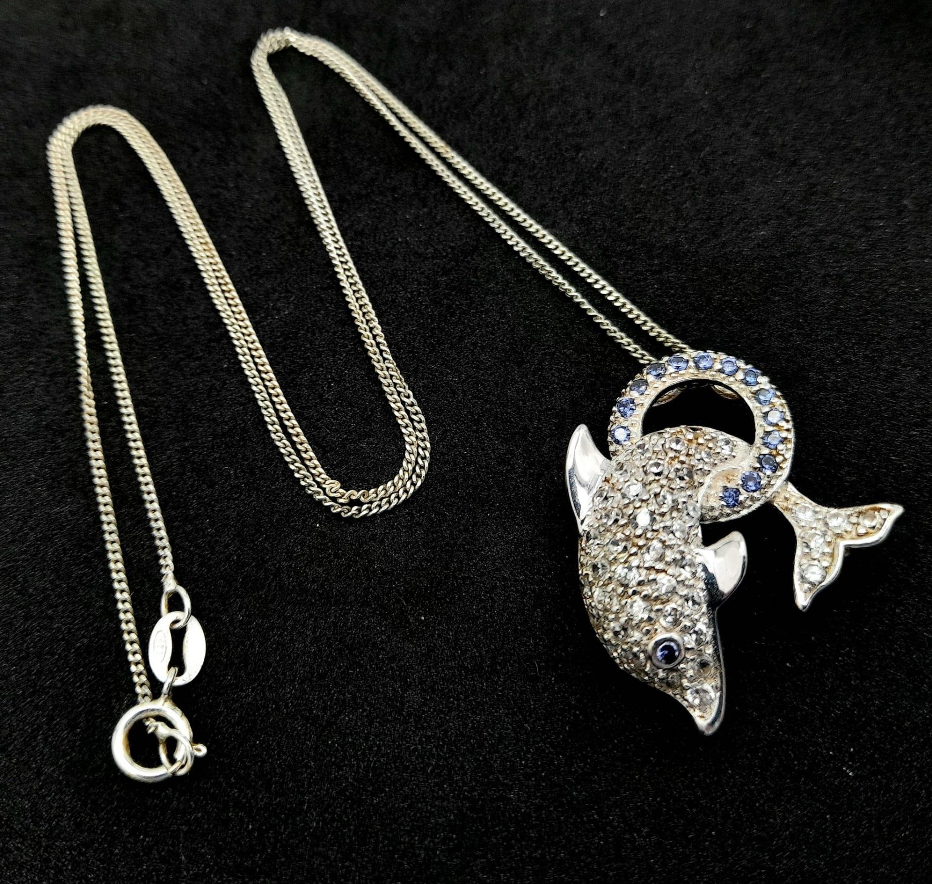 An Unworn Sterling Silver Stone Set Dolphin Pendant Necklace in Presentation Box. 46cm Length.