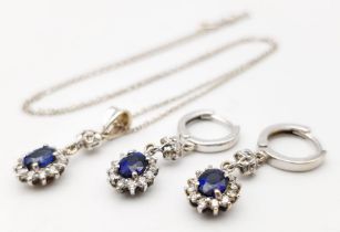 An 18K White Gold, Diamond and Sapphire Jewellery Set. Oval cut sapphire with diamond surround on an