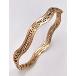 A Vintage 9K Rose Gold Undulating Large Bangle. Pierced geometric decoration. 17.6g weight.