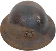 WW1 US Brodie Helmet with USMC Cap Badge and Camo Paint Job. The liner is complete, alas the chin