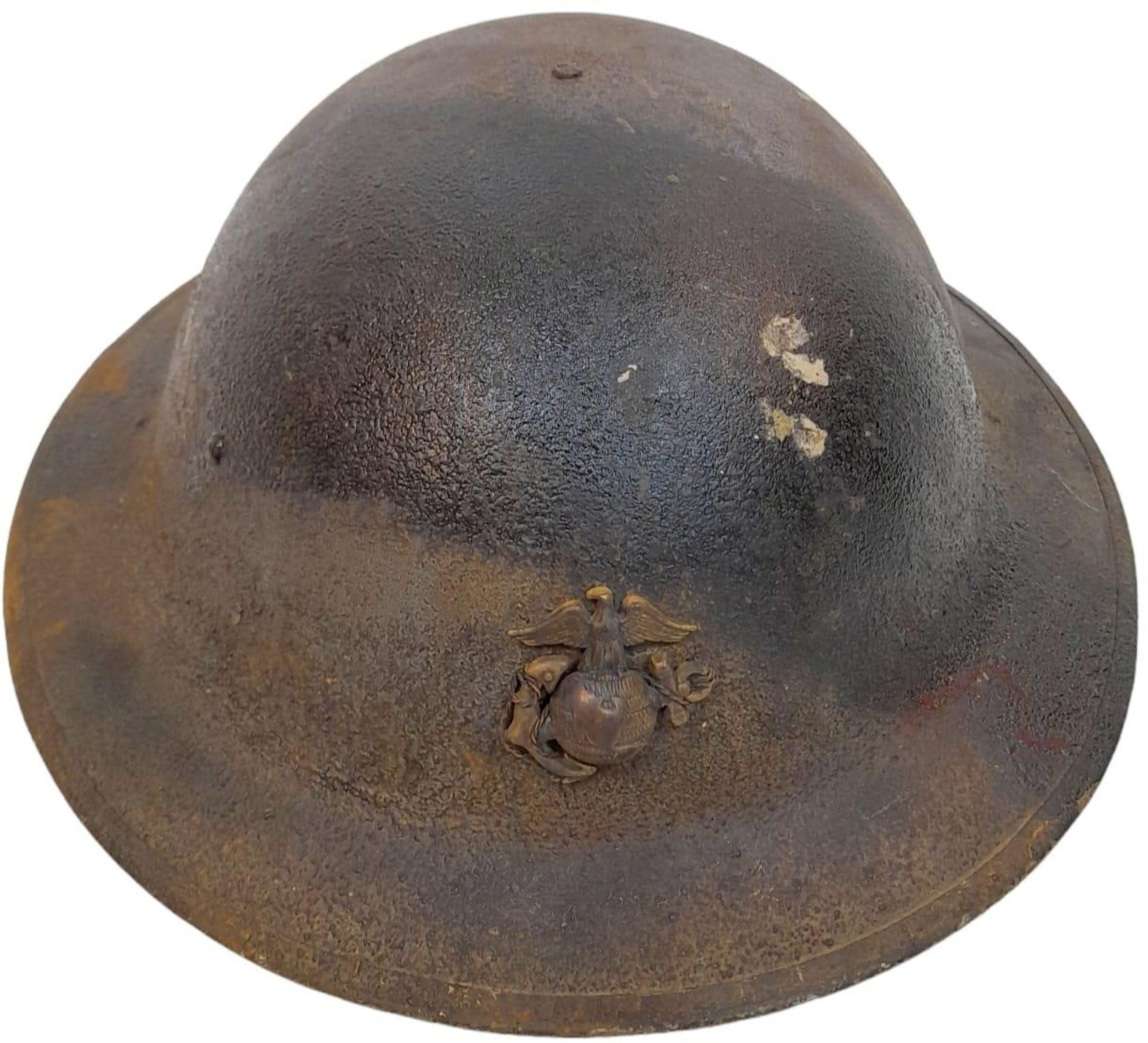 WW1 US Brodie Helmet with USMC Cap Badge and Camo Paint Job. The liner is complete, alas the chin