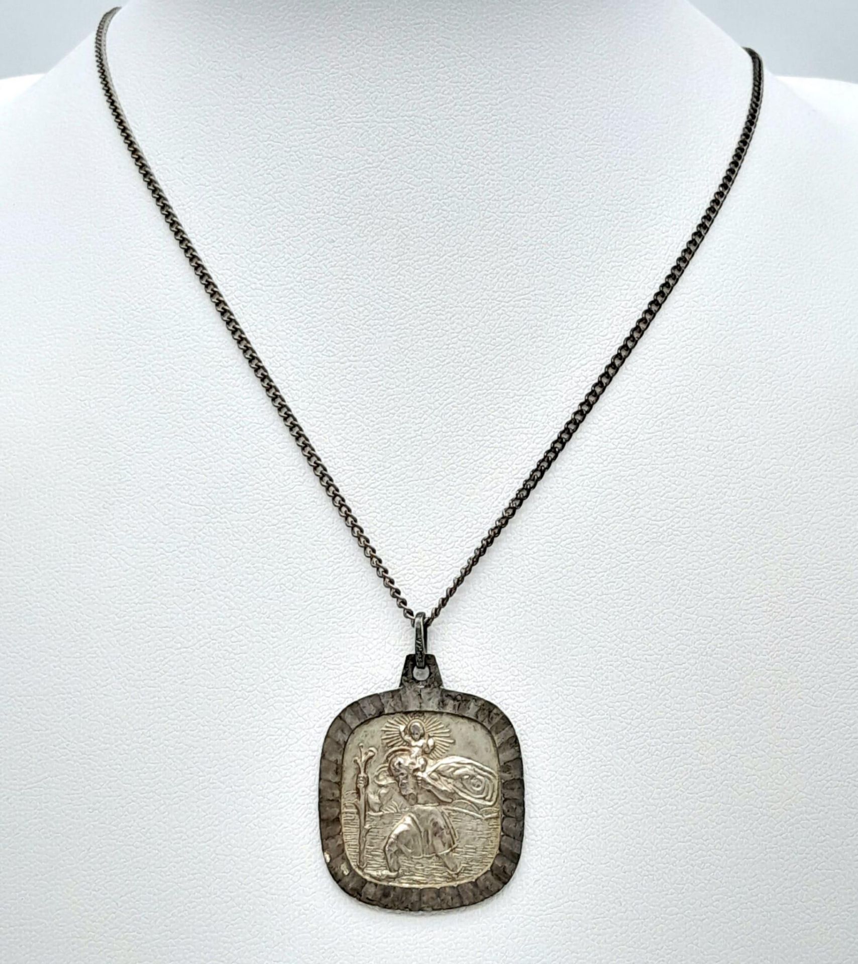 A vintage 925 silver St Christopher pendant on silver chain. Total weight 10.7G. Total length 53cm.